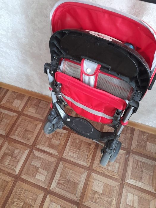 Детская коляска красного цвета