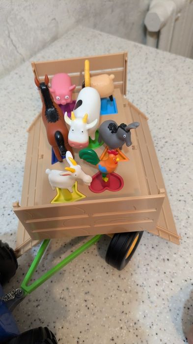 Синий трактор с прицепом и животными