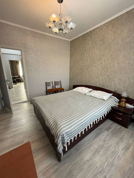 Кровать двуспальная имеет две прикроватные тумбочки