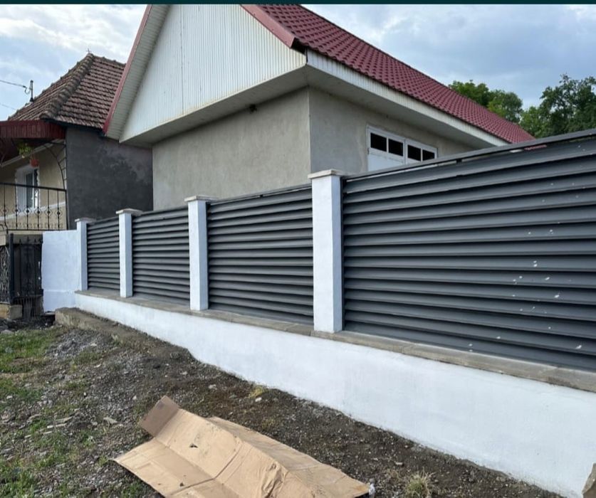 Construim la comanda dvs. garduri si porti din:
- panouri stil jaluzea;
- șipcă metalică;
- fier forjat;
- tablă cutată;
- plasă bordurată;
- BCA sau