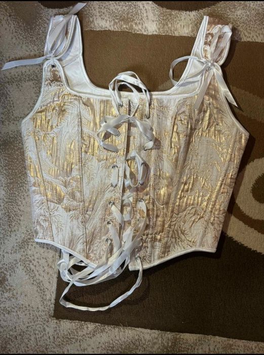 Corset alb cu detalii aurii

elegant şi

versatil