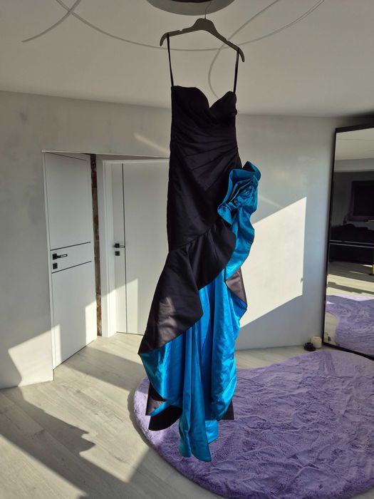 Официална дизайнерска рокля с висока цепка и син акцент.