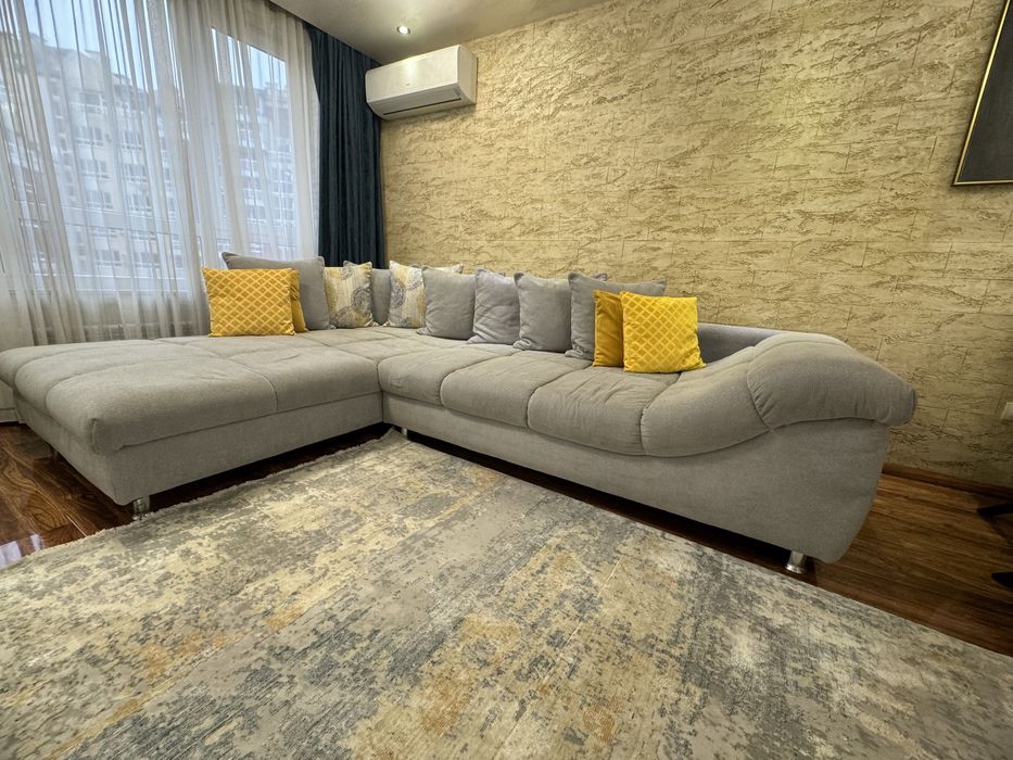 Сив ъглов диван с декоративни възглавници