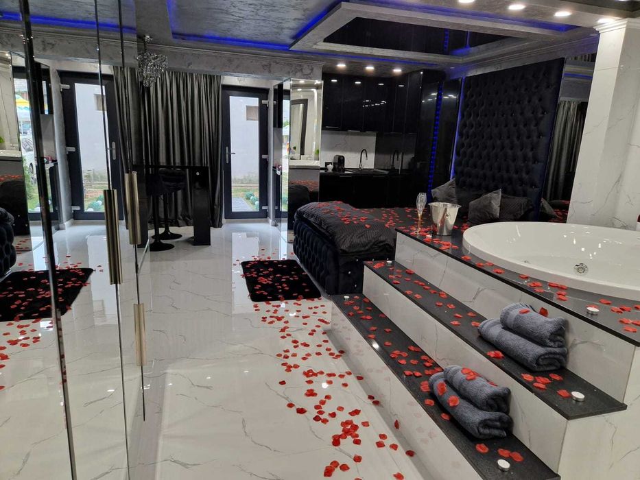 Regim hotelier cu jacuzzi in camera, oglinda deasupra patului