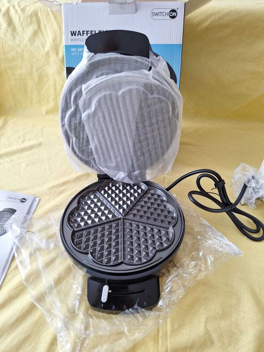 Aparat de făcut vafe/gofre model Switch On WM-A201 are o putere de 1200 W,  suprafață de coacere împărțită în formă de vafe rotunde divizate