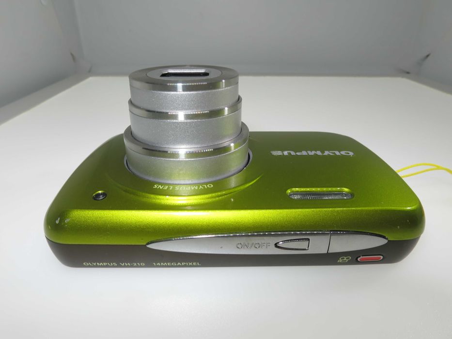Olympus VH 210 ултра компактен фотоапарат в страхотен свеж зелен цвят и състояние като НОВО, тестван и работи отлично, пълен комплект