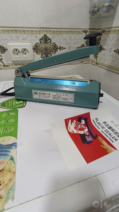 Paket yopishtirish apparati