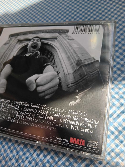 CD Cheloo, intitulat „Sindromul Tourette”, lansat în 2003 prin casa de discuri Rebel Music, Muzica Hip Hop Romanesc