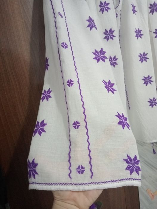 Ie cusuta manual pe panza topita
