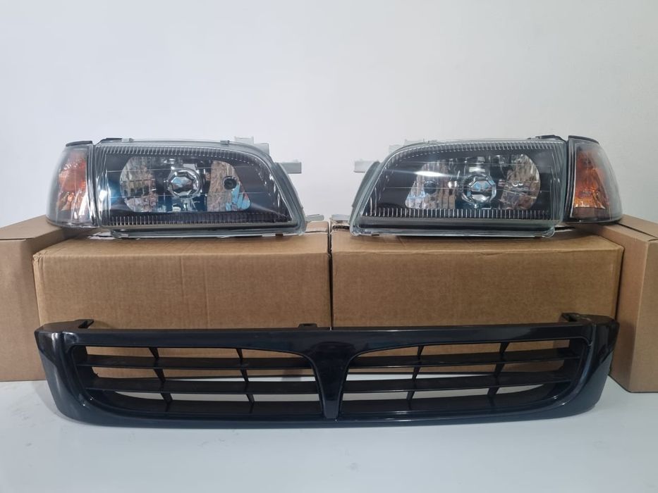 Карина Е бампера, фары, капот, крыло, решетка