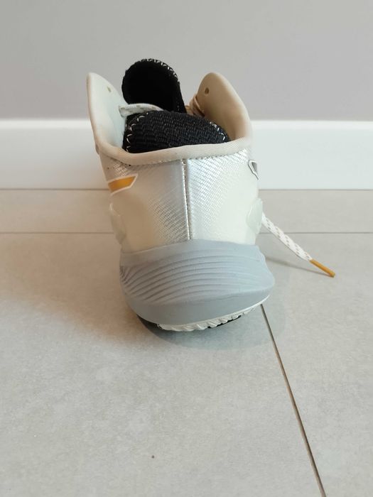 Asics meterise white and gold line.