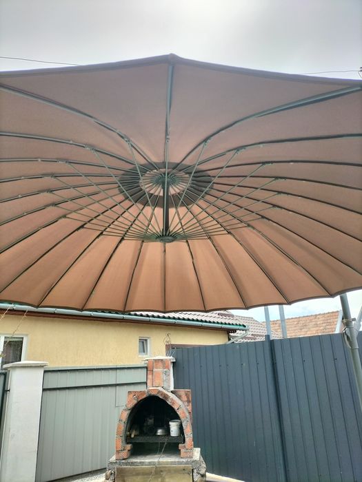 Umbrela de vânzare aproape nouă este din material foarte rezistent la apa este aproape nouă.