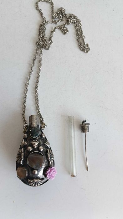 Старинно колие е флакон за парфюм  изработено от метал с декорация от камъни.