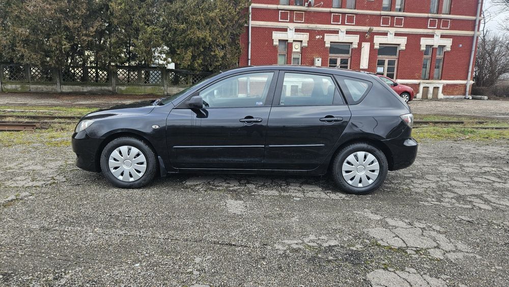 Mazda 3  an 2008 1.3 benzina