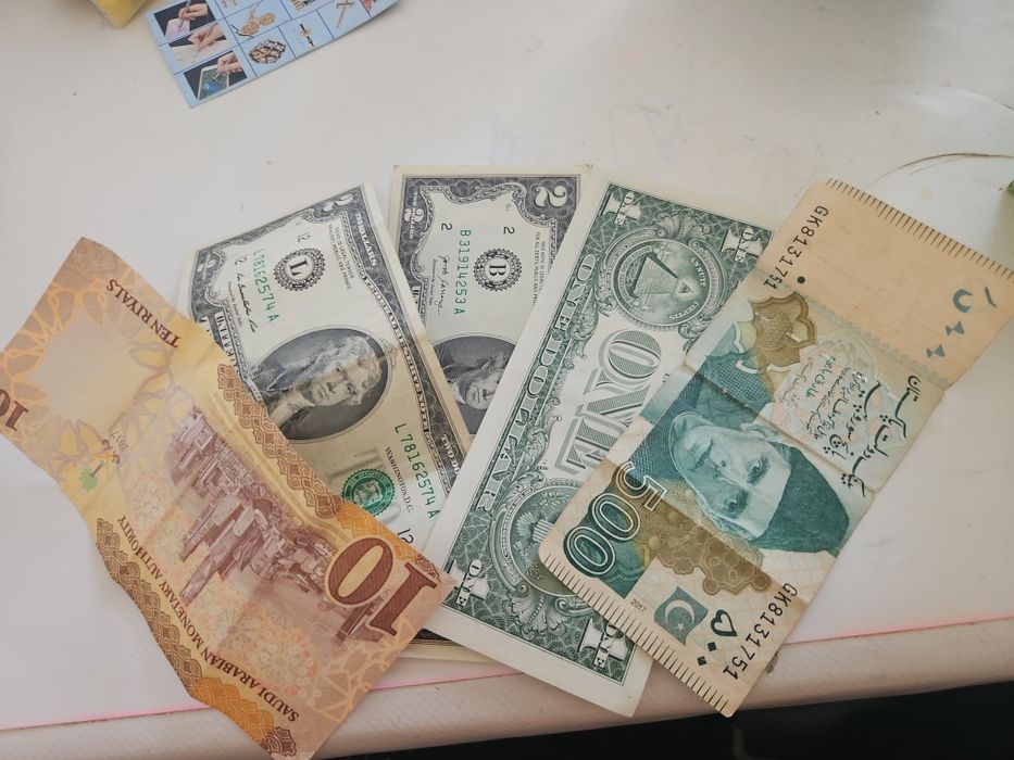 Доллар риял и пакистанская купюра