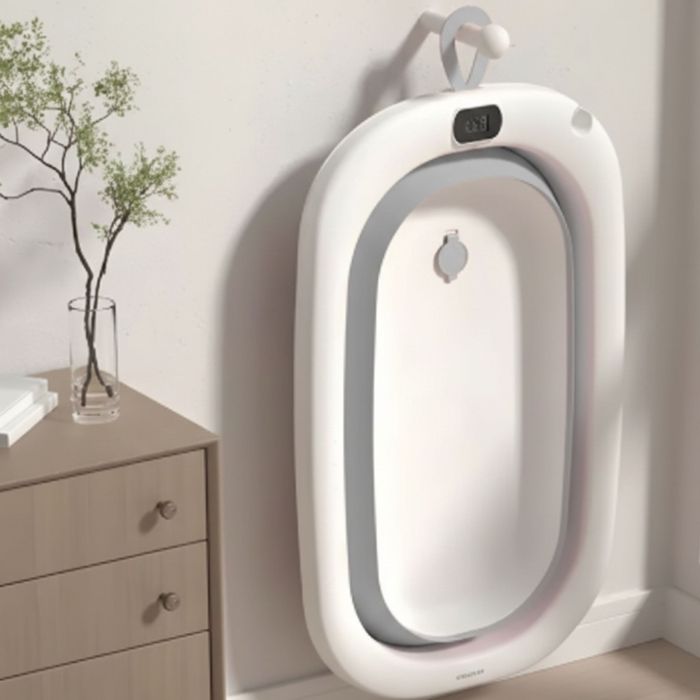 Сгъваема бебешка вана с термометър и възглавница.