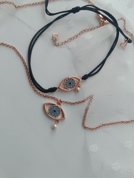 Комплект на Oxette колие и гривна в розово злато със синьо око