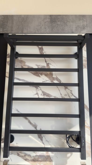 Полотенцесушитель с полочкой черного цвет от производителя.