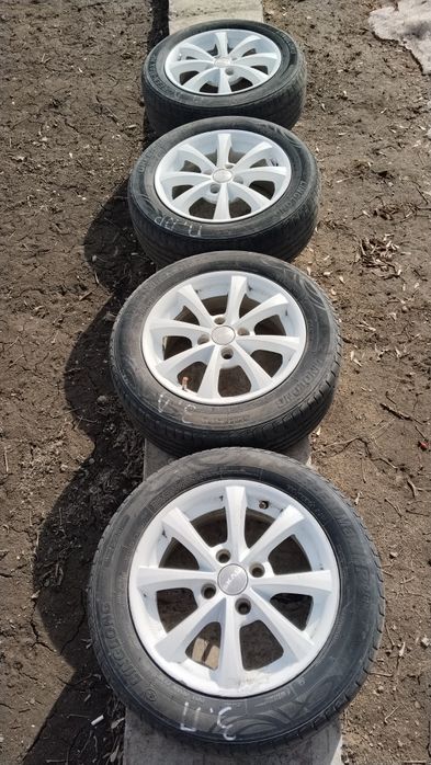 Продам Оригинальные титановые диски R 14 с покрышкой 185/60.