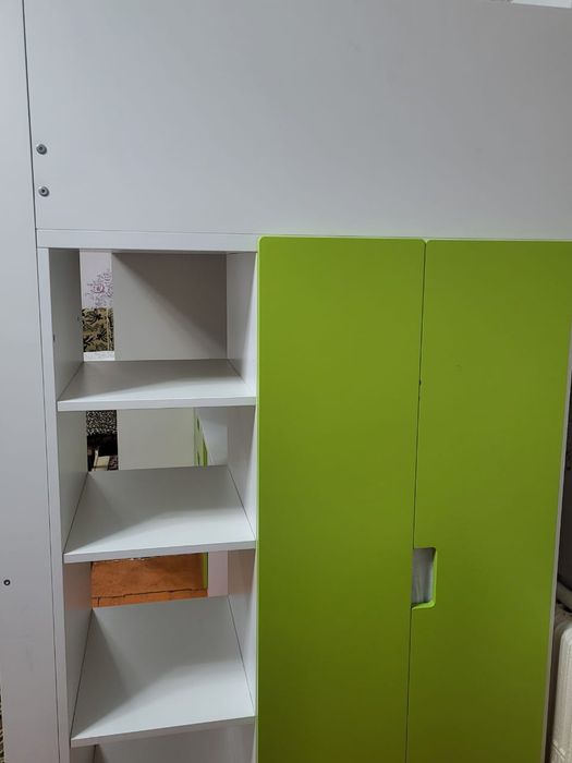 Детская кровать со шкафом и столом.