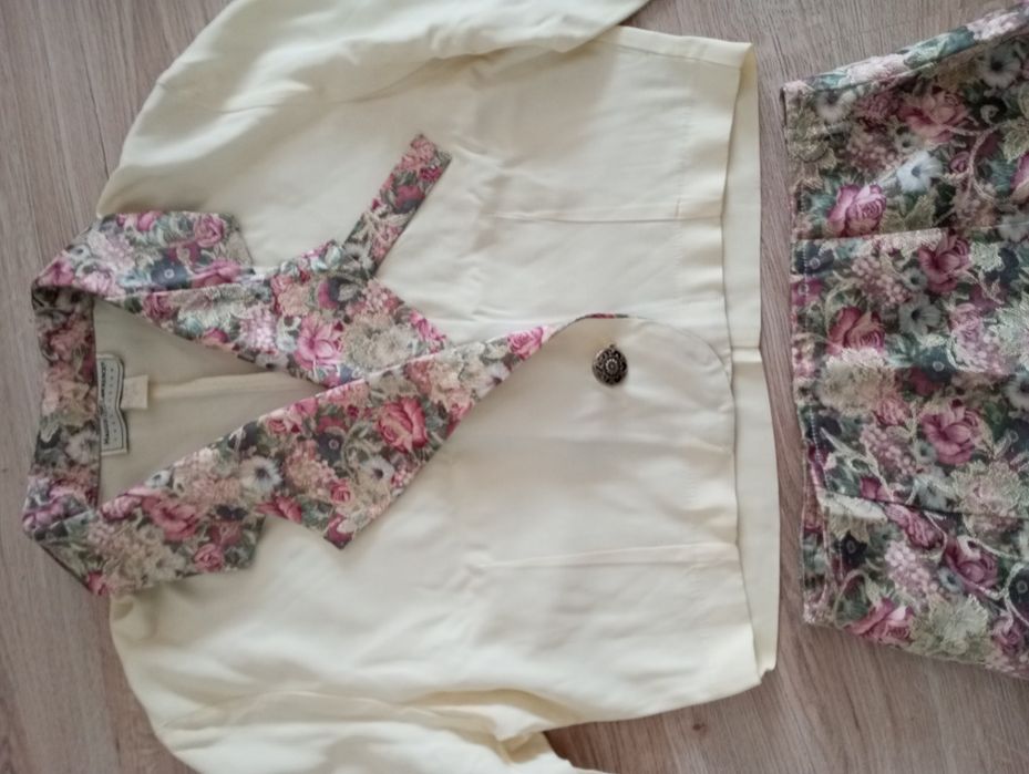 Compleu format din bluză cu garnitură florală de mătase și fustă .