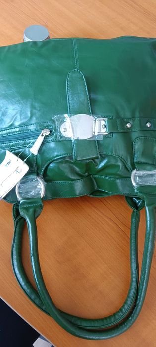 Дамска чанта от зелена еко кожа с къса и с дълга дръжка и ефектна катарама.Разпределението вътре е от две отделения и преграда с цип в средата