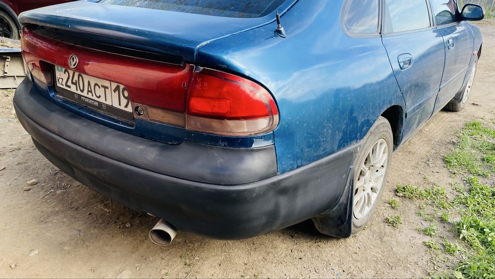 Задний бампер Mazda Cronos