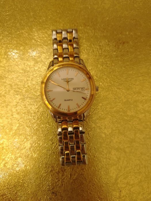 По фото видно кварцевые часы Longines с окошком дня недели и даты (day