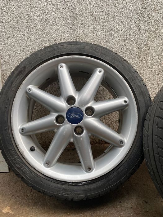 Jante originale Ford 16" 4x108 (8 spițe) + Anvelope Taurus 195/45 R16 (DOT 2025 / 2021)