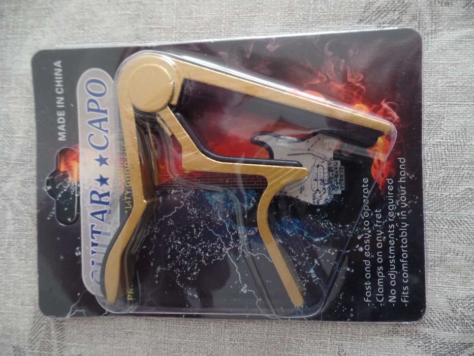 Каподастр и струны для гитары новые.