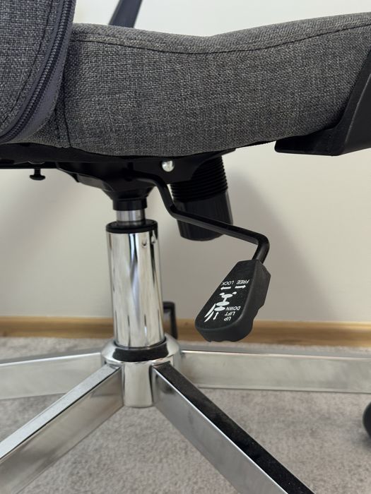 Ергономичен офис стол със сива текстилна тапицерия и метална основа