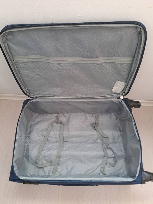 Голям текстилен куфар с вътрешен механизъм.