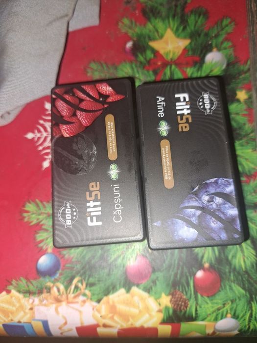 Un iqos și doua cuti cu filtre cu arome