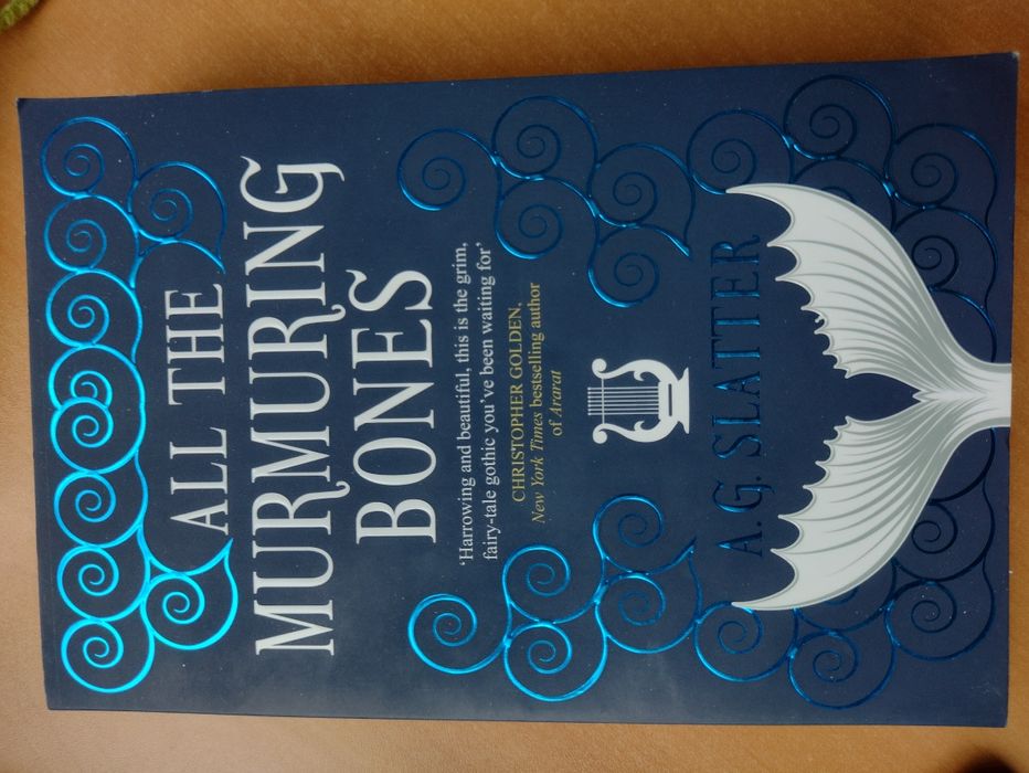Фентъзи книга на английски- All the murmuring bones- A. G. Slatter