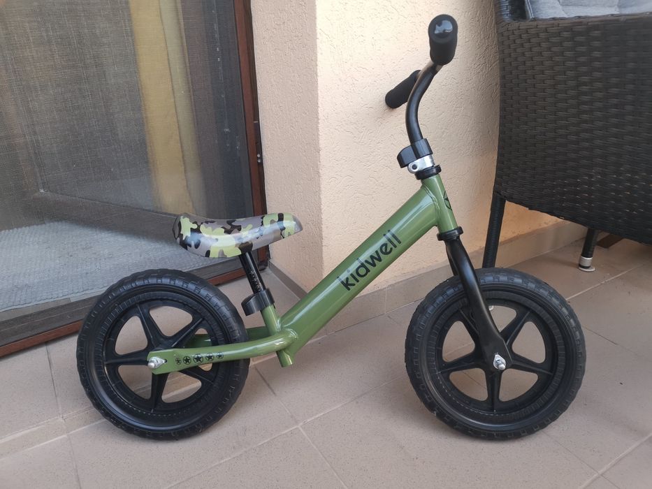 Bicicletă fără pedale pentru echilibru Kidwell REBEL 12” Kaki – roți EVA – stare foarte bună