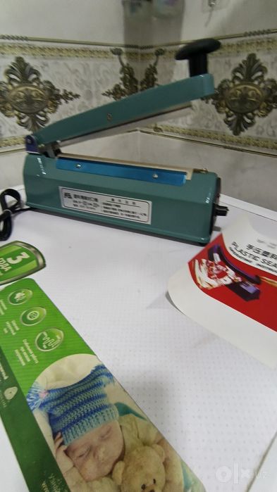Paket yopishtirish apparati