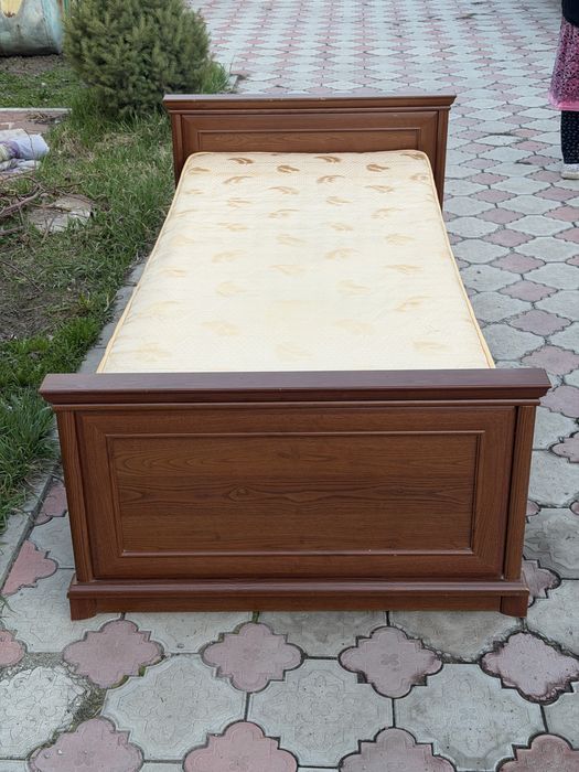 деревянная кровать с матрасом.