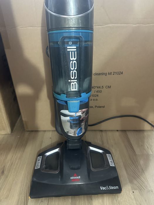 Bissell Vac & Steam 2-in-1 titanium and blue vertical vacuum cleaner and steam mop.