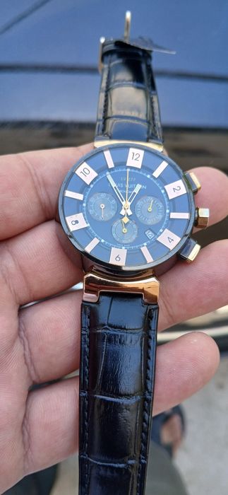 Это — модель Louis Vuitton Tambour LV‑277 Chronograph, где «LV‑277» об