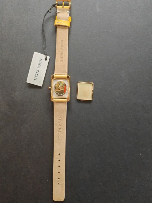 Ceas de dama Nina Ricci  auriu cu cadran alb original, nou  fără cutie
