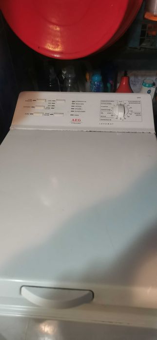 пералня с горно зареждане AEG с повреда пада ремъка