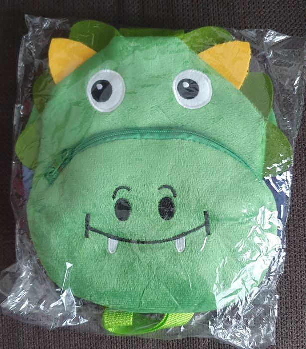 Зелена малка раница във формата на динозавър