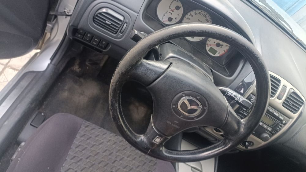 Мазда 323 по запчастям 2002год выпуска.
