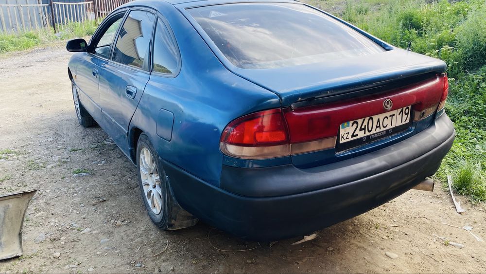 Задний бампер Mazda Cronos