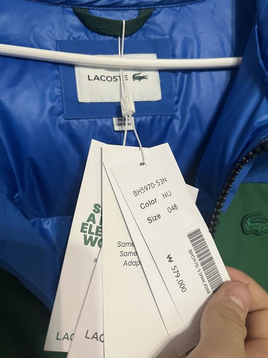 Пуховик бренда Lacoste