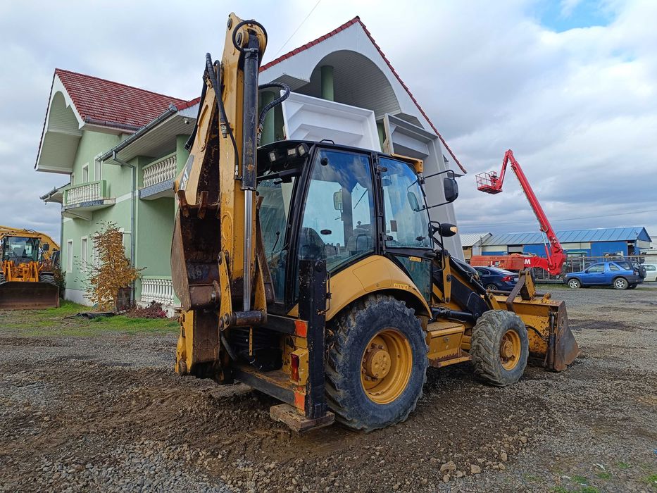 Buldoexcavator CATERPILLAR 428E , cupa multifunctionala