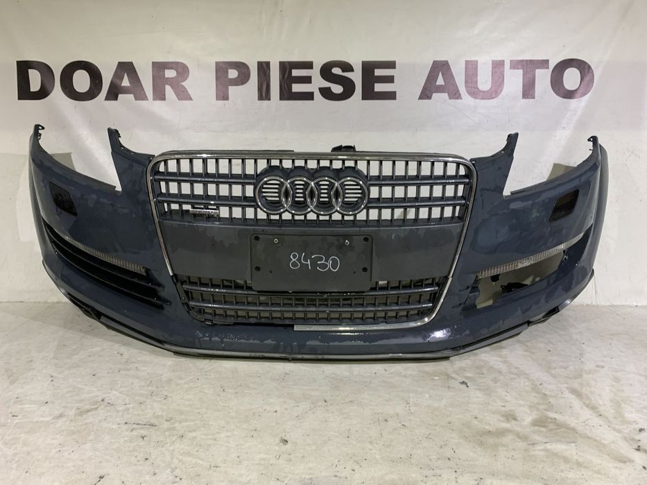 Bara fata Audi Q7, 2006, 2007, 2008, 2009, 2010, cod origine OE 4L0807437, cu gauri pentru spalatori faruri. Bara este noua, spoilerul atins si grila radiator defecta.