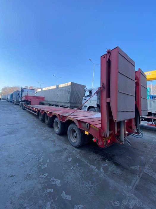 Полуприцеп тяжеловоз низкорамный Feilida-60т Tral podushka Orient Ozod