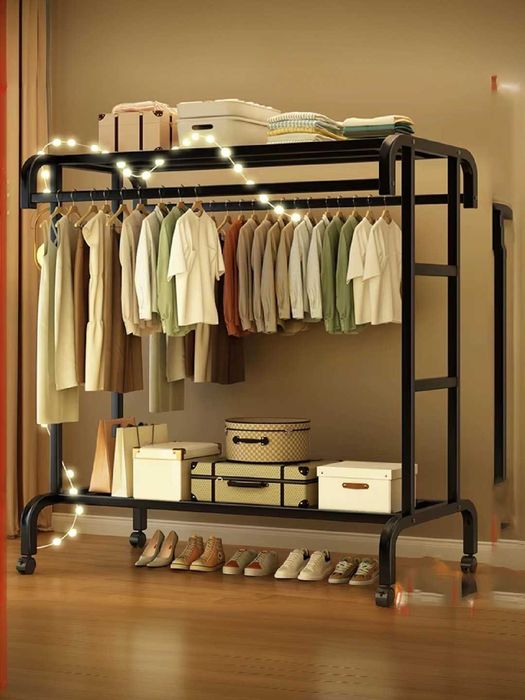 An open clothes rack made of thick metal that stands on the floor
