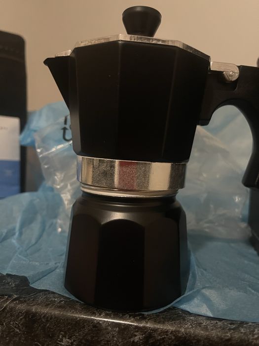 Cafetiera pentru aragaz de la Iqos si punga de cafea macinata